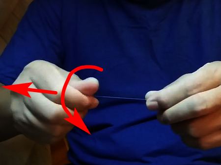 At the same time,  slide your dominat hand smoothly outward from your body (red arrow).