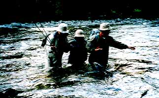 They walk accrossed the river with shoulder to shoulder.