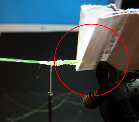 I use several sheets of paper to cushion the line because it gets scratched when I pinch it directly with the vice.